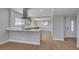 Modern kitchen with wood cabinets, white countertops, and sleek wood floors at 4807 Sacks Dr, Las Vegas, NV 89122