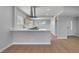 Modern kitchen with wood cabinets, white countertops, and sleek wood floors at 4807 Sacks Dr, Las Vegas, NV 89122