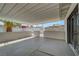 Spacious covered patio with concrete flooring and gated access to backyard at 4807 Sacks Dr, Las Vegas, NV 89122