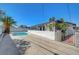 A view of the backyard pool and palm tree, enclosed by a privacy wall at 4807 Sacks Dr, Las Vegas, NV 89122