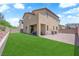 Expansive backyard featuring lush green grass, covered patio and brick paved area at 4833 Royal Magnolia St, North Las Vegas, NV 89031