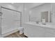 A bathroom featuring a glass shower, toilet, and vanity with bright lighting at 4833 Royal Magnolia St, North Las Vegas, NV 89031