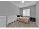 Cozy bedroom with neutral carpet and an organized dresser with a few decorations at 4833 Royal Magnolia St, North Las Vegas, NV 89031