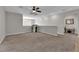 Spacious bonus room features neutral colors, a ceiling fan, and lots of natural light at 4833 Royal Magnolia St, North Las Vegas, NV 89031