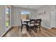 A cozy dining area with natural light, a dark wood table, and comfortable seating at 4833 Royal Magnolia St, North Las Vegas, NV 89031