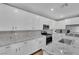 Well-lit kitchen showcasing granite countertops, white cabinets, and stainless steel appliances at 4833 Royal Magnolia St, North Las Vegas, NV 89031