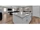 Bright, open kitchen featuring an island with granite counters and stainless sink at 4833 Royal Magnolia St, North Las Vegas, NV 89031