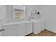 Laundry room with washer, dryer, storage cabinets, and countertop space at 4833 Royal Magnolia St, North Las Vegas, NV 89031