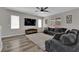 A living room with carpet, and an entertainment center with a wall-mounted TV at 4833 Royal Magnolia St, North Las Vegas, NV 89031