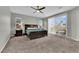 Spacious main bedroom featuring a ceiling fan, carpet and ample natural light at 4833 Royal Magnolia St, North Las Vegas, NV 89031