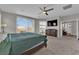 Large main bedroom with ceiling fan, a large window, plush carpeting, and ensuite bath at 4833 Royal Magnolia St, North Las Vegas, NV 89031