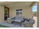 Cozy covered patio with comfortable seating, ideal for outdoor relaxation and entertaining at 4833 Royal Magnolia St, North Las Vegas, NV 89031