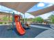 Community playground with slides, climbing structures, and shade for  at 4833 Royal Magnolia St, North Las Vegas, NV 89031