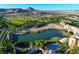 Aerial view of the community, golf course, mountains, pool, and lake at 49 Charlotte Ridge Pl, Henderson, NV 89011