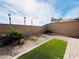 Landscaped backyard with stone and astroturf at 49 Charlotte Ridge Pl, Henderson, NV 89011