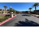 Gated entrance to a community with palm trees and well-maintained landscaping at 49 Charlotte Ridge Pl, Henderson, NV 89011