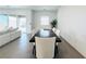 Bright dining room features modern table, white chairs, and a sliding glass door at 49 Charlotte Ridge Pl, Henderson, NV 89011
