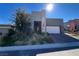 Stunning single-story home featuring modern architecture and desert landscaping at 49 Charlotte Ridge Pl, Henderson, NV 89011