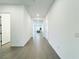 Long hallway features tile flooring and access to other rooms in the home at 49 Charlotte Ridge Pl, Henderson, NV 89011