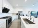 Modern kitchen with stainless steel appliances, white cabinets, and marble countertops at 49 Charlotte Ridge Pl, Henderson, NV 89011