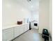 Well-lit laundry room with ample storage cabinets and modern washer/dryer at 49 Charlotte Ridge Pl, Henderson, NV 89011