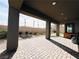 Covered patio with stone pavers and desert landscaping at 49 Charlotte Ridge Pl, Henderson, NV 89011