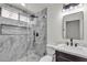 Modern bathroom featuring a glass-enclosed shower with marble tile and a stylish vanity at 4911 Ranchodomingo Ct, North Las Vegas, NV 89031