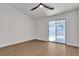 Spacious bedroom with wood flooring and a sliding glass door to the backyard at 4911 Ranchodomingo Ct, North Las Vegas, NV 89031