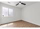 This bedroom has hard surface floors, a window, and a ceiling fan at 4911 Ranchodomingo Ct, North Las Vegas, NV 89031