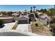 Single story home with desert landscaping, a two car garage and solar panels at 4911 Ranchodomingo Ct, North Las Vegas, NV 89031