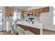 Stylish kitchen featuring stone backsplash, an island with seating, and stainless steel appliances at 4911 Ranchodomingo Ct, North Las Vegas, NV 89031