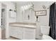 Bright bathroom with a white vanity, decorative mirror, and clean, modern design at 5008 Donnie Ave, Las Vegas, NV 89130