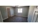 Neutral bedroom showcasing gray carpeting, a ceiling fan, and a bright window at 5008 Donnie Ave, Las Vegas, NV 89130