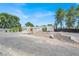Charming single-story home with a stucco facade, double front doors, and ample gravel parking area at 5008 Donnie Ave, Las Vegas, NV 89130