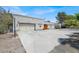View of the home's garage featuring two garage doors and an extended driveway at 5008 Donnie Ave, Las Vegas, NV 89130