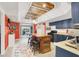 A large kitchen island with seating, complemented by dark blue cabinets and plenty of natural light from the backyard view at 5008 Donnie Ave, Las Vegas, NV 89130