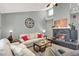 Comfortable living room with a fireplace, sofa, and natural light at 5008 Donnie Ave, Las Vegas, NV 89130