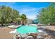 Backyard featuring a pool, jacuzzi, lounge seating, and lush greenery, creating a serene and inviting outdoor space at 5008 Donnie Ave, Las Vegas, NV 89130