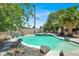 Outdoor pool area with rock features, jacuzzi, lounge chairs, and lush greenery, ideal for relaxation and entertainment at 5008 Donnie Ave, Las Vegas, NV 89130