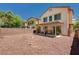 Backyard view featuring an exterior patio structure, privacy walls and desert landscaping at 5220 Melbourne Ridge Ct, Las Vegas, NV 89141