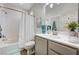 Clean bathroom with shower over tub, modern vanity, and decorative touches at 5220 Melbourne Ridge Ct, Las Vegas, NV 89141
