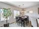 Inviting dining area with a dark wood table, seating for six, and a stylish pendant light fixture at 5220 Melbourne Ridge Ct, Las Vegas, NV 89141
