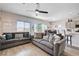 Bright living room featuring hardwood floors, sofas, and a ceiling fan at 5220 Melbourne Ridge Ct, Las Vegas, NV 89141