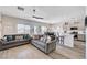 Open-concept living room featuring hardwood floors, sofas, and ceiling fan at 5220 Melbourne Ridge Ct, Las Vegas, NV 89141