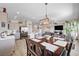 Open concept kitchen and dining area with a view of the living room featuring a wall-mounted TV and comfortable seating at 5220 Melbourne Ridge Ct, Las Vegas, NV 89141