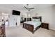 Primary bedroom featuring ceiling fan, carpet floors, and ensuite bathroom at 5220 Melbourne Ridge Ct, Las Vegas, NV 89141