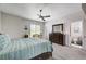 A primary bedroom boasts a ceiling fan, carpet floors, and ensuite bathroom at 5220 Melbourne Ridge Ct, Las Vegas, NV 89141