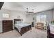 Bright main bedroom with plush carpet, ceiling fan, and generous natural light at 5220 Melbourne Ridge Ct, Las Vegas, NV 89141