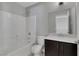 Updated bathroom with a shower-tub combo, white tile surround, and modern fixtures at 5484 Mercury Springs Dr, Las Vegas, NV 89122