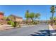 Copper Creek Estates gated entrance with lush desert landscaping and visitor parking at 5484 Mercury Springs Dr, Las Vegas, NV 89122